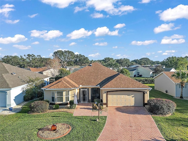 single story home featuring a front lawn and a garage