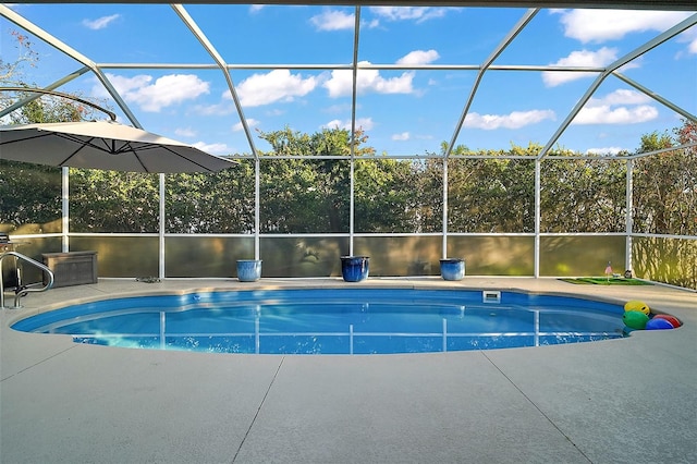 view of pool featuring glass enclosure