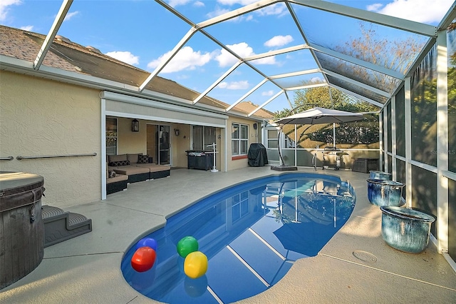 view of pool featuring a lanai, a patio, and outdoor lounge area