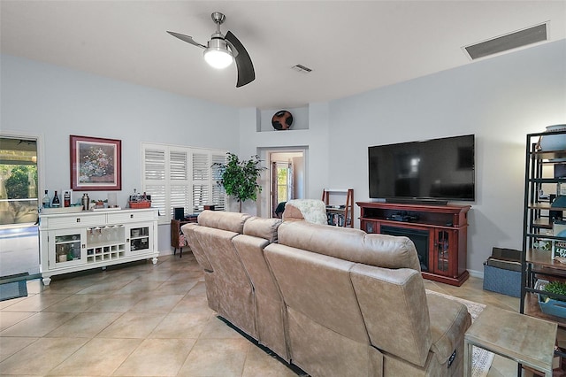 living room with ceiling fan and light tile patterned floors