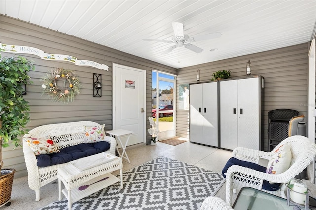 interior space with ceiling fan