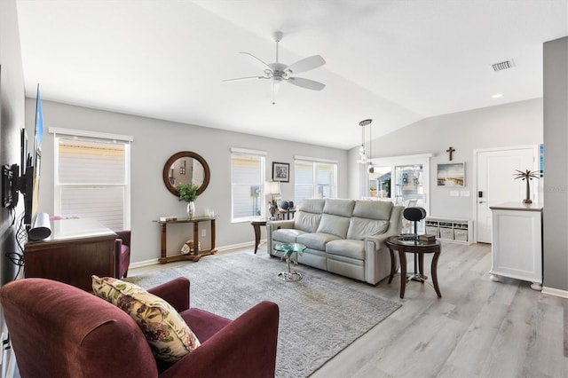 living room with ceiling fan, light hardwood / wood-style flooring, and vaulted ceiling