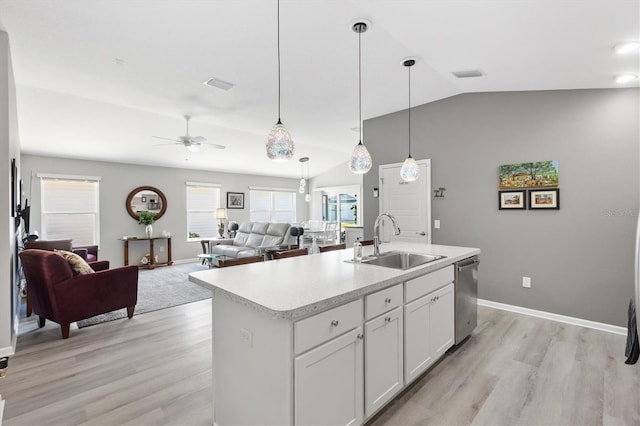 kitchen featuring ceiling fan, dishwasher, sink, white cabinetry, and a kitchen island with sink