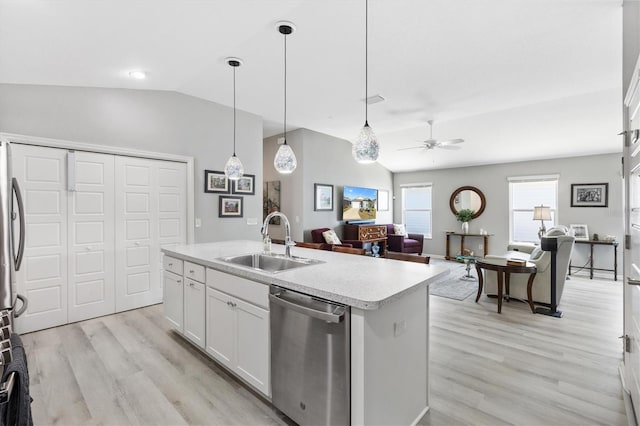 kitchen featuring appliances with stainless steel finishes, white cabinetry, a kitchen island with sink, vaulted ceiling, and ceiling fan