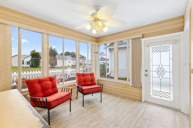 sunroom featuring ceiling fan and a wealth of natural light