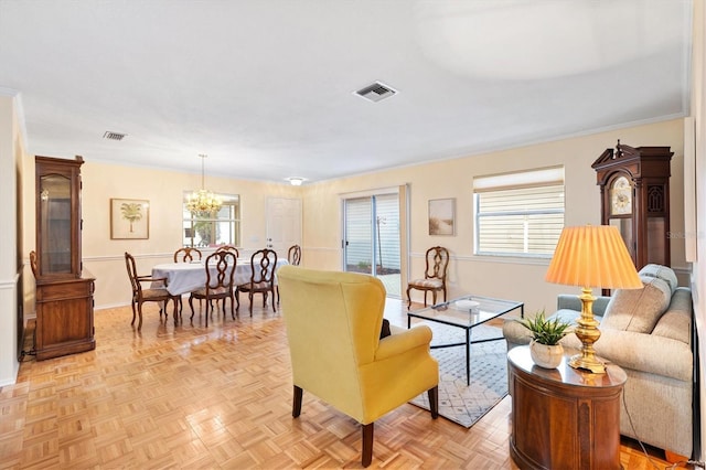 living room featuring an inviting chandelier and light parquet floors