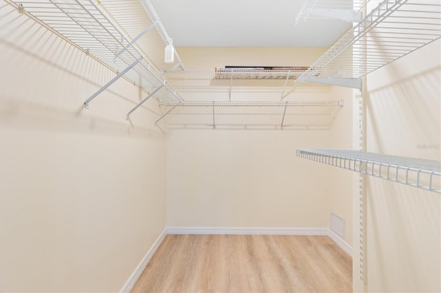 spacious closet featuring hardwood / wood-style floors