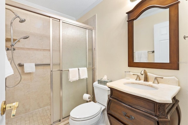 bathroom featuring vanity, toilet, a shower with door, and crown molding