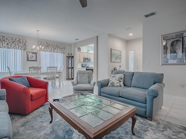 living room featuring light tile patterned floors and a notable chandelier