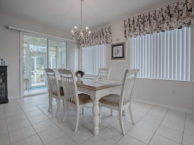 tiled dining space featuring a notable chandelier