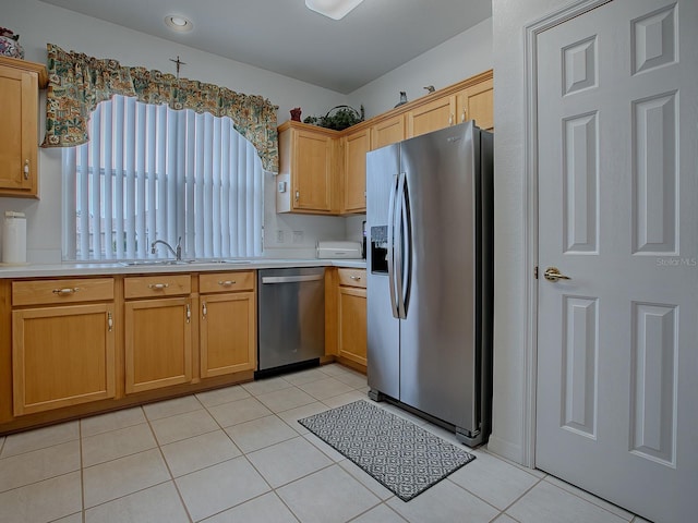 kitchen with sink, stainless steel appliances, and light tile patterned floors