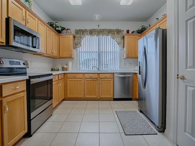 kitchen featuring sink, light tile patterned floors, and appliances with stainless steel finishes