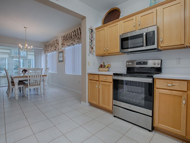 kitchen with stainless steel appliances, light brown cabinets, light tile patterned floors, pendant lighting, and a notable chandelier