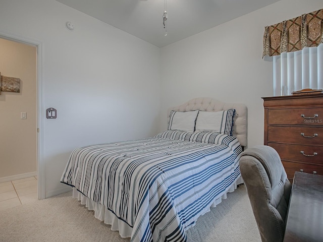 bedroom featuring light carpet