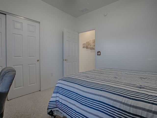 bedroom featuring a closet and light colored carpet