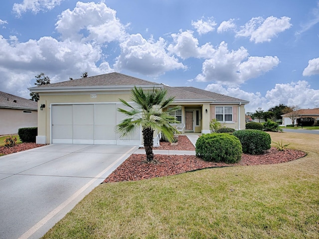 ranch-style house featuring a front yard and a garage