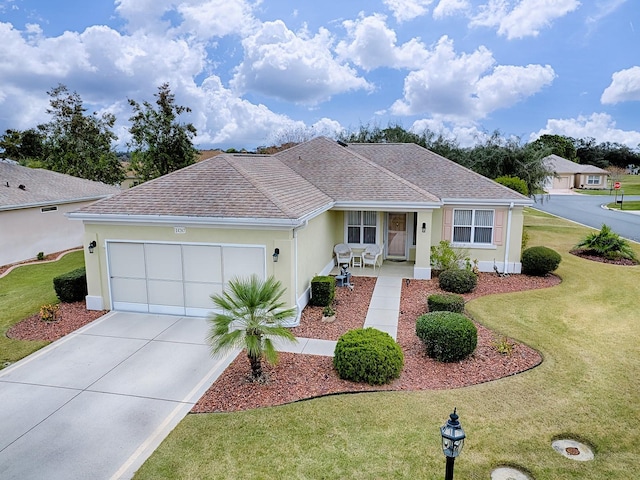 single story home with covered porch, a front yard, and a garage