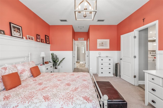 carpeted bedroom with a notable chandelier