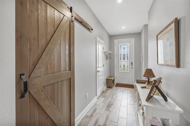 doorway with a barn door and light hardwood / wood-style floors