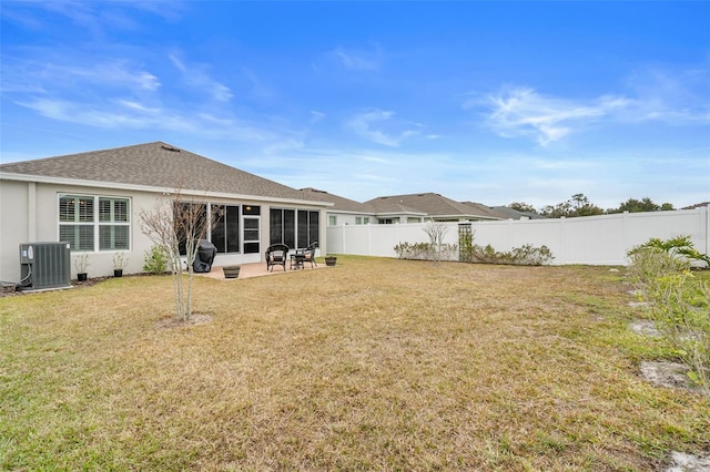 back of house featuring cooling unit, a patio, a yard, and a sunroom