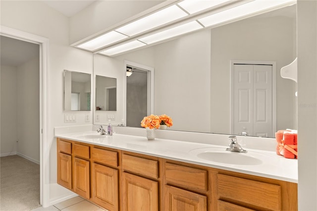 full bathroom featuring tile patterned flooring, a sink, and double vanity