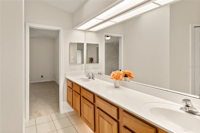 bathroom featuring double vanity, a sink, and tile patterned floors