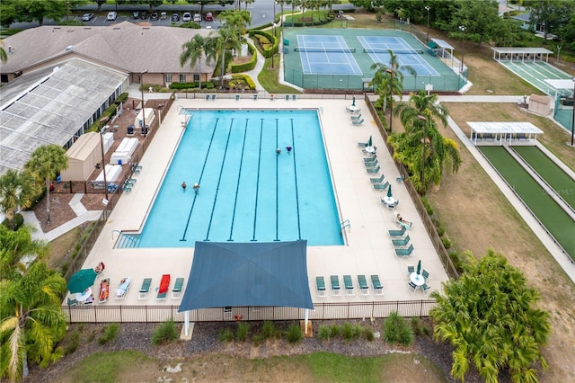 view of swimming pool featuring fence