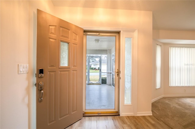 entryway with light wood-type flooring and baseboards