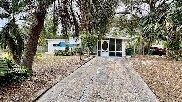 back of property with a sunroom