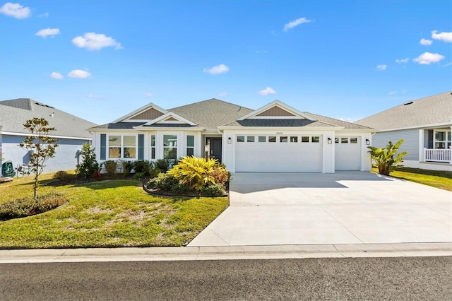 ranch-style house featuring a garage and a front yard