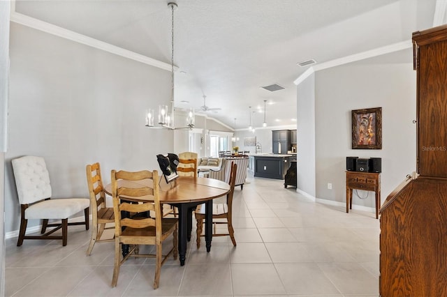 tiled dining room featuring lofted ceiling, ceiling fan with notable chandelier, crown molding, and a textured ceiling