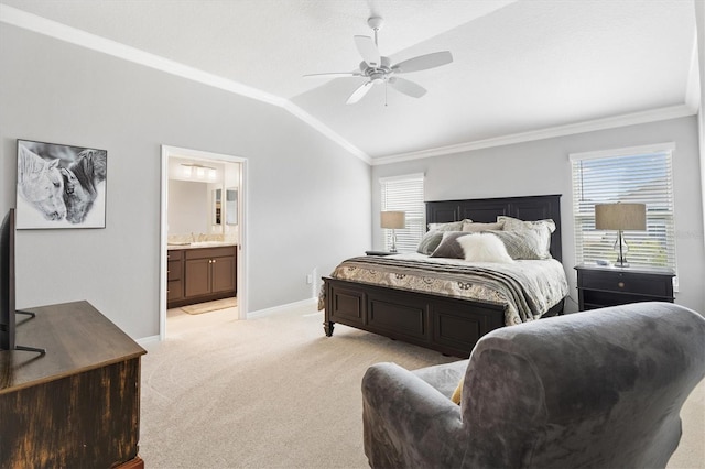 bedroom with ceiling fan, light colored carpet, lofted ceiling, crown molding, and connected bathroom