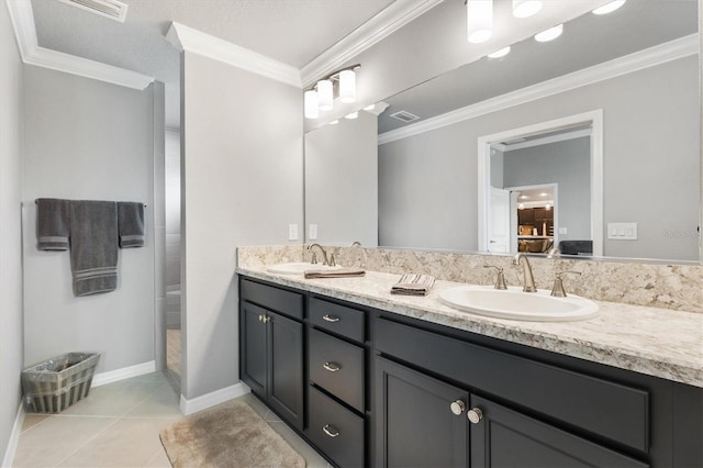 bathroom featuring a shower, vanity, crown molding, and tile patterned flooring