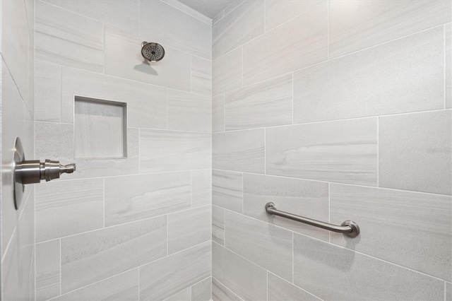 bathroom with tiled shower