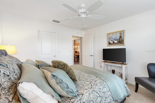 carpeted bedroom featuring ceiling fan and a closet