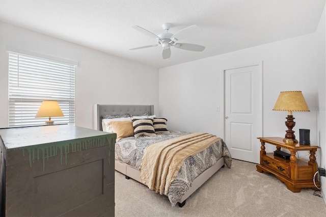 bedroom featuring ceiling fan and light colored carpet