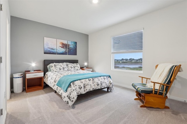 bedroom featuring light colored carpet