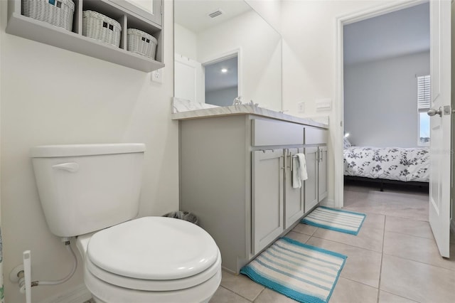 bathroom featuring toilet and tile patterned flooring