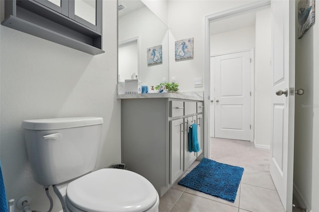 bathroom featuring tile patterned flooring, vanity, and toilet