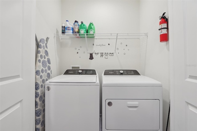 clothes washing area with separate washer and dryer