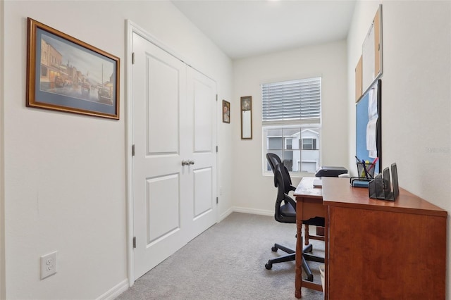 office area featuring light carpet