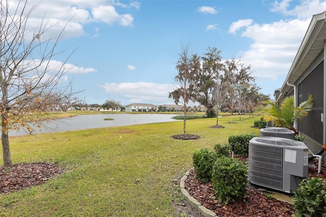 view of yard featuring a water view and central air condition unit