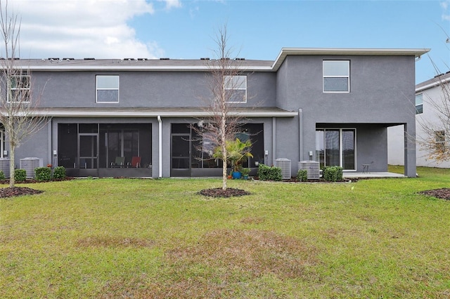 rear view of house featuring central AC unit, a lawn, and a sunroom