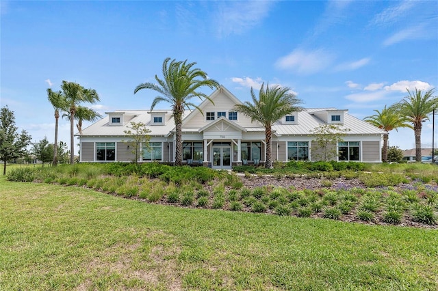 view of front facade with a front yard and french doors