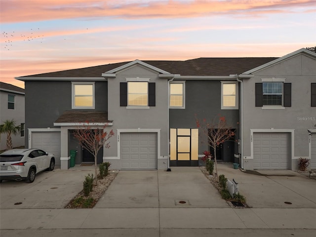 townhome / multi-family property featuring a garage