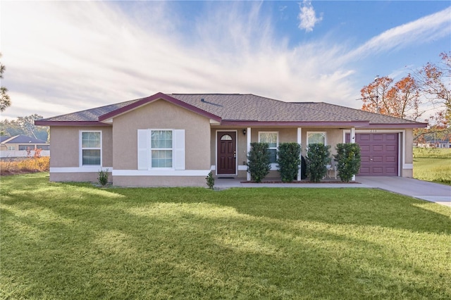 ranch-style home featuring a garage and a front lawn