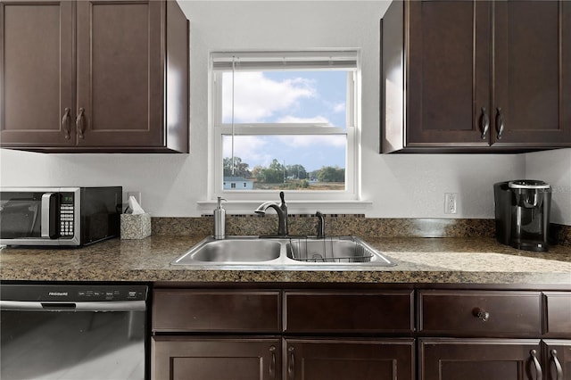 kitchen with dark brown cabinetry, black dishwasher, and sink