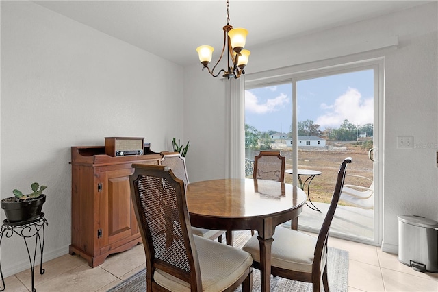 tiled dining area featuring a notable chandelier