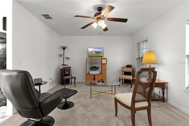 living area featuring ceiling fan and light carpet