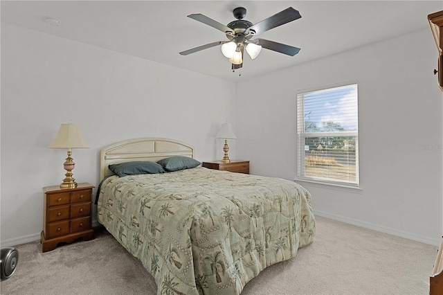 bedroom featuring light colored carpet and ceiling fan